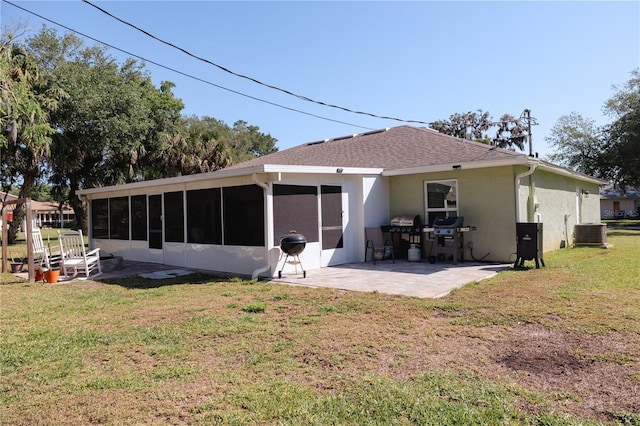 2204 Kumquat Dr, Edgewater, FL 32141 - rear view of property featuring central AC, stucco siding, a sunroom, a patio area, and a lawn