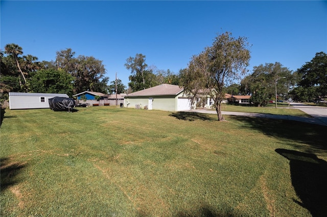 2204 Kumquat Dr, Edgewater, FL 32141 - view of yard with an attached garage