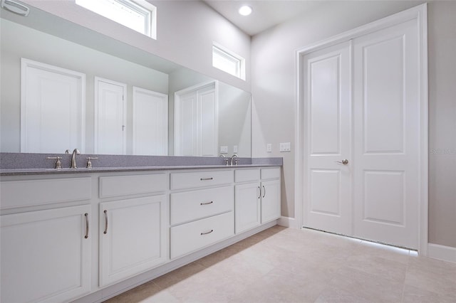 6277 W Fallsgrove Ln, Port Orange, FL 32128 - full bathroom featuring tile patterned floors, double vanity, baseboards, and a sink