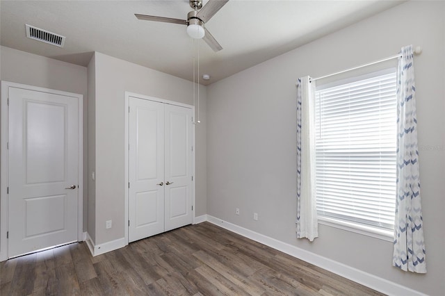 6277 W Fallsgrove Ln, Port Orange, FL 32128 - unfurnished bedroom with baseboards, a closet, visible vents, and wood finished floors