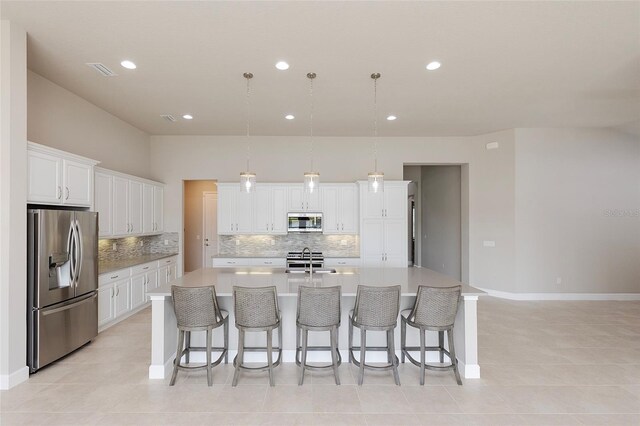 6277 W Fallsgrove Ln, Port Orange, FL 32128 - kitchen featuring a sink, stainless steel appliances, a large island, backsplash, and white cabinets