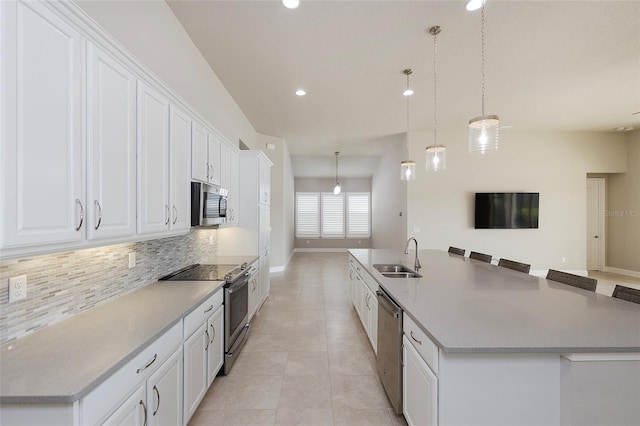 6277 W Fallsgrove Ln, Port Orange, FL 32128 - kitchen with backsplash, a spacious island, stainless steel appliances, and a sink