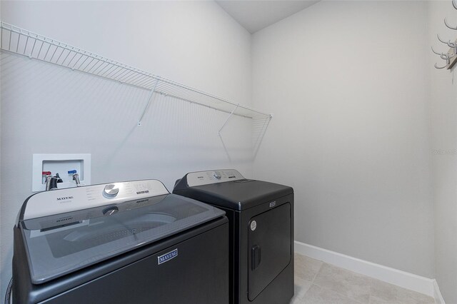 6277 W Fallsgrove Ln, Port Orange, FL 32128 - laundry room with laundry area, baseboards, light tile patterned floors, and independent washer and dryer