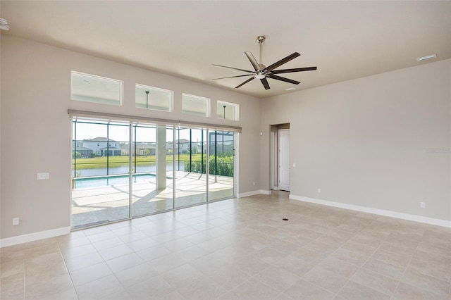 6277 W Fallsgrove Ln, Port Orange, FL 32128 - empty room featuring light tile patterned floors, baseboards, and a ceiling fan