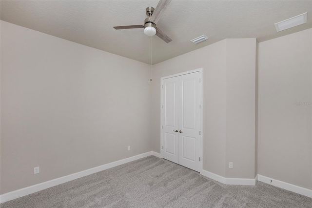 6277 W Fallsgrove Ln, Port Orange, FL 32128 - unfurnished bedroom featuring light carpet, a textured ceiling, baseboards, and visible vents