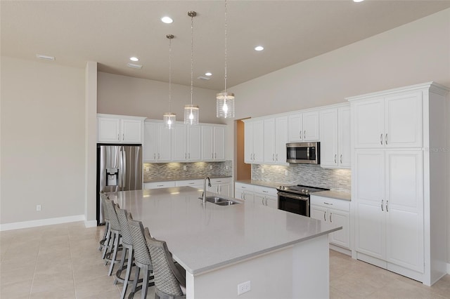 6277 W Fallsgrove Ln, Port Orange, FL 32128 - kitchen featuring a sink, stainless steel appliances, tasteful backsplash, a large island with sink, and light tile patterned floors