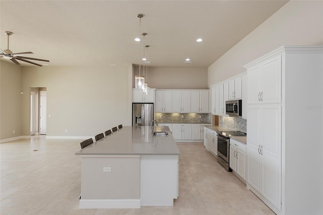 6277 W Fallsgrove Ln, Port Orange, FL 32128 - kitchen featuring a ceiling fan, light tile patterned floors, a sink, decorative backsplash, and appliances with stainless steel finishes