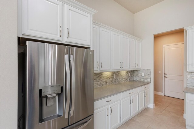 6277 W Fallsgrove Ln, Port Orange, FL 32128 - kitchen with stainless steel refrigerator with ice dispenser, white cabinetry, backsplash, light countertops, and light tile patterned flooring