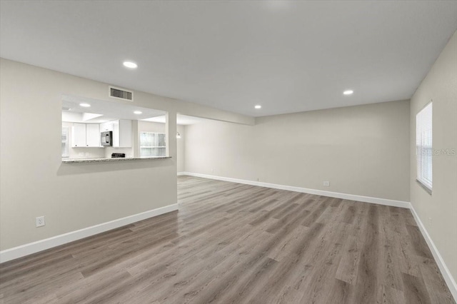 3644 Dame St, Port Orange, FL 32129 - unfurnished living room featuring light wood finished floors, baseboards, visible vents, and recessed lighting
