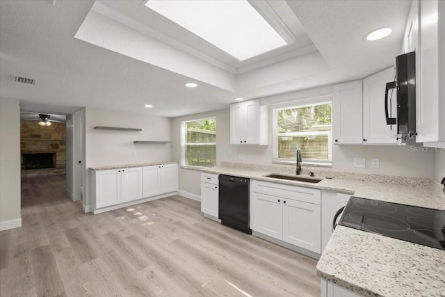 3644 Dame St, Port Orange, FL 32129 - kitchen with white cabinets, a fireplace, a sink, and black appliances