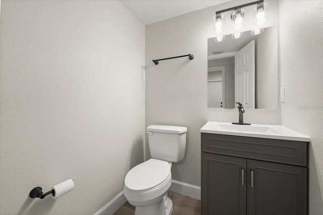 3644 Dame St, Port Orange, FL 32129 - bathroom featuring baseboards, wood finished floors, vanity, and toilet