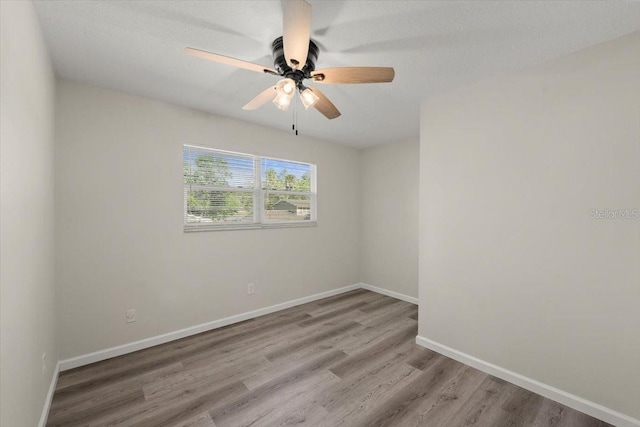 3644 Dame St, Port Orange, FL 32129 - empty room with wood finished floors, baseboards, and ceiling fan