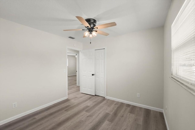 3644 Dame St, Port Orange, FL 32129 - unfurnished bedroom with wood finished floors, a closet, and baseboards