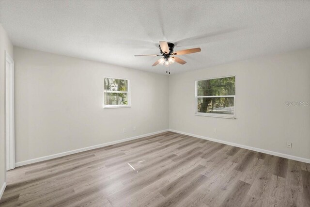 3644 Dame St, Port Orange, FL 32129 - spare room with baseboards, a ceiling fan, wood finished floors, and a textured ceiling