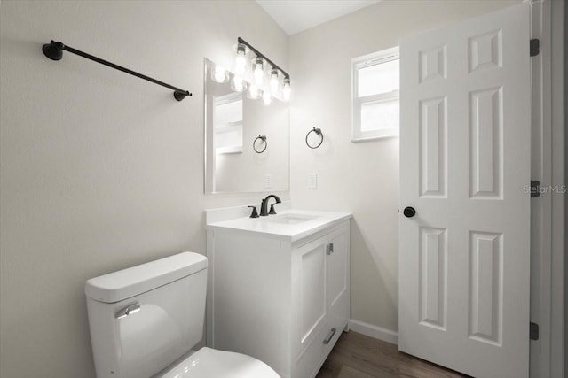 3644 Dame St, Port Orange, FL 32129 - bathroom with toilet, vanity, wood finished floors, and baseboards