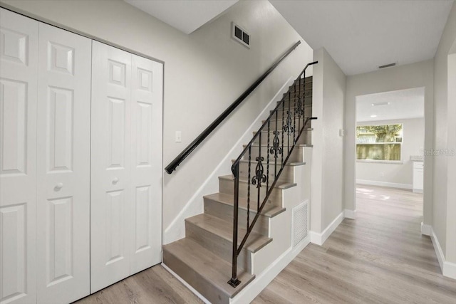 3644 Dame St, Port Orange, FL 32129 - staircase with baseboards, wood finished floors, and visible vents