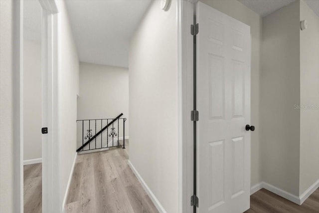 3644 Dame St, Port Orange, FL 32129 - hall with wood finished floors, baseboards, and an upstairs landing