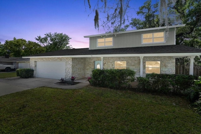 3644 Dame St, Port Orange, FL 32129 - traditional-style house featuring stone siding, an attached garage, a front yard, and concrete driveway