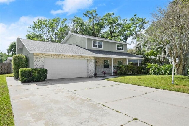 3644 Dame St, Port Orange, FL 32129 - traditional home with concrete driveway, an attached garage, stone siding, a porch, and a front yard