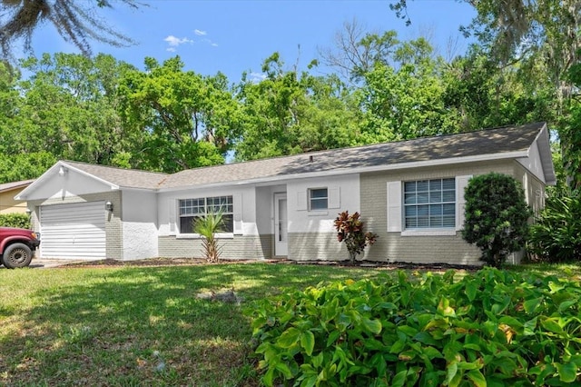 single story home featuring brick siding, an attached garage, and a front lawn