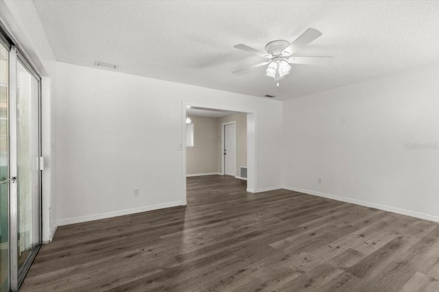 empty room featuring dark wood-style floors, a textured ceiling, and ceiling fan