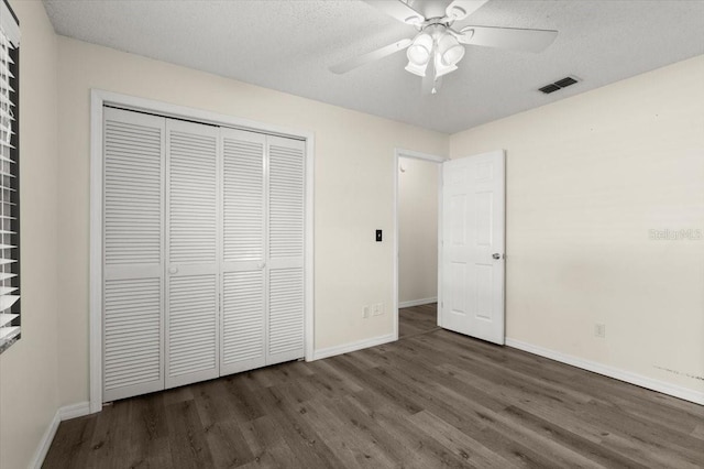 unfurnished bedroom featuring visible vents, baseboards, and wood finished floors