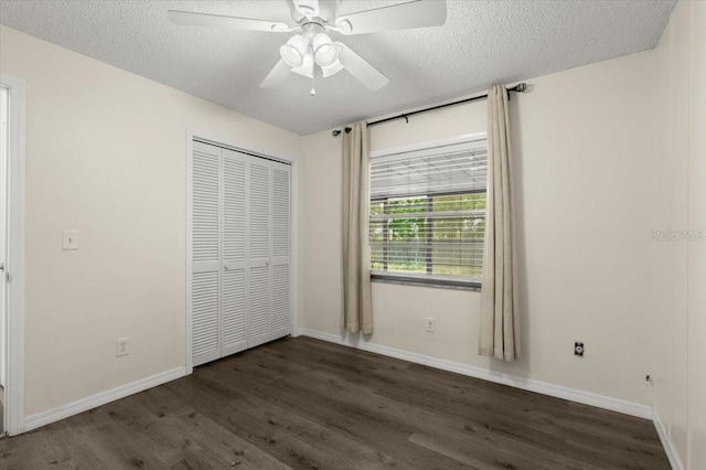 unfurnished bedroom featuring a closet, wood finished floors, and a textured ceiling