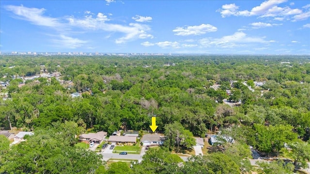 bird's eye view with a wooded view