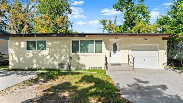 557 Berkshire Rd, Daytona Beach, FL 32114 - ranch-style house with concrete driveway, central AC, and a garage