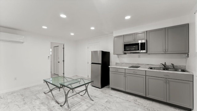 557 Berkshire Rd, Daytona Beach, FL 32114 - kitchen featuring a sink, recessed lighting, a wall mounted air conditioner, gray cabinets, and appliances with stainless steel finishes