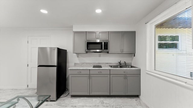 557 Berkshire Rd, Daytona Beach, FL 32114 - kitchen featuring marble finish floor, appliances with stainless steel finishes, gray cabinets, and a sink