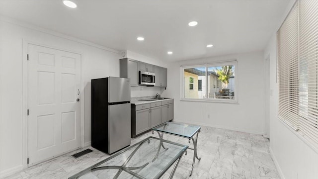 557 Berkshire Rd, Daytona Beach, FL 32114 - kitchen with gray cabinets, marble finish floor, appliances with stainless steel finishes, and recessed lighting