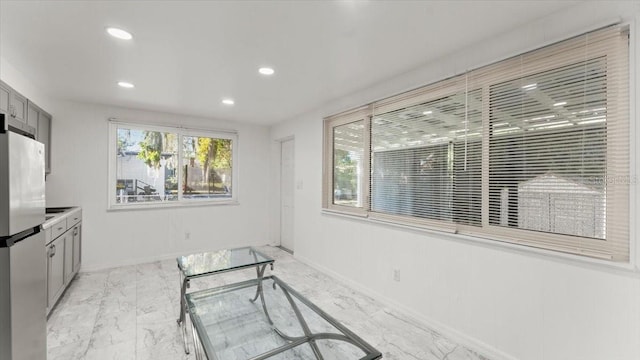 557 Berkshire Rd, Daytona Beach, FL 32114 - kitchen with baseboards, freestanding refrigerator, recessed lighting, marble finish floor, and gray cabinets