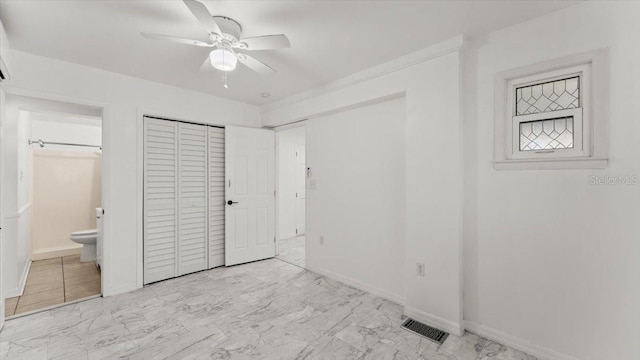 557 Berkshire Rd, Daytona Beach, FL 32114 - unfurnished bedroom featuring connected bathroom, marble finish floor, baseboards, and visible vents