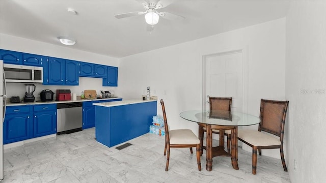 557 Berkshire Rd, Daytona Beach, FL 32114 - kitchen featuring stainless steel appliances, light countertops, visible vents, a ceiling fan, and blue cabinetry