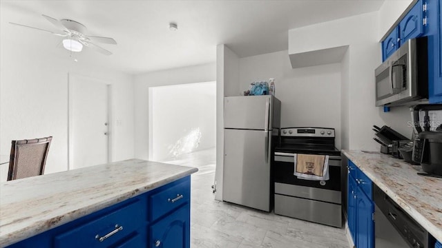 557 Berkshire Rd, Daytona Beach, FL 32114 - kitchen with blue cabinets, marble finish floor, appliances with stainless steel finishes, and ceiling fan
