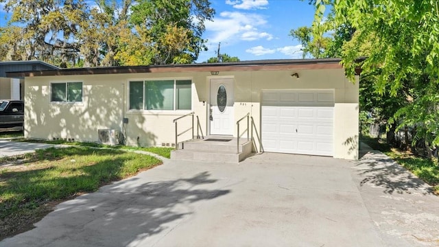 557 Berkshire Rd, Daytona Beach, FL 32114 - ranch-style home featuring concrete driveway, an attached garage, and stucco siding