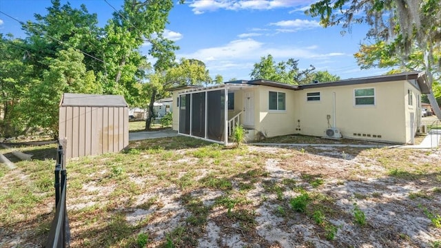 557 Berkshire Rd, Daytona Beach, FL 32114 - back of house featuring an outdoor structure, a storage unit, a sunroom, and crawl space