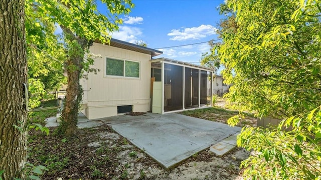 557 Berkshire Rd, Daytona Beach, FL 32114 - rear view of house featuring a patio area and a sunroom