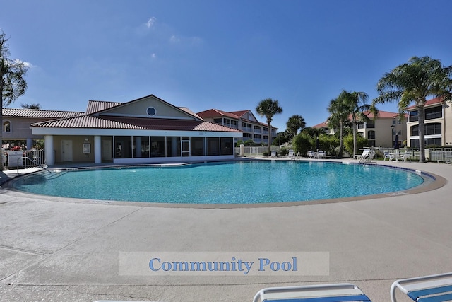 community pool featuring fence and a patio