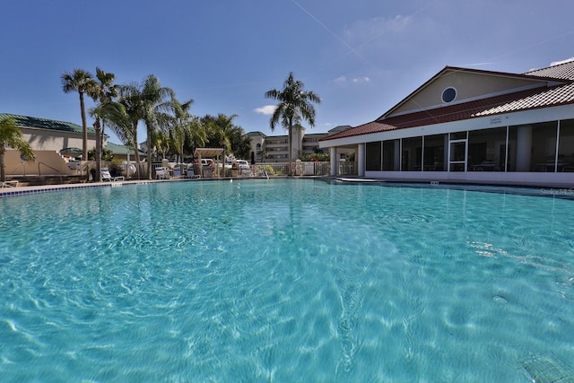 community pool featuring a sunroom