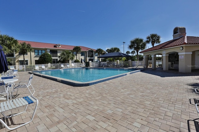 pool featuring a patio and fence