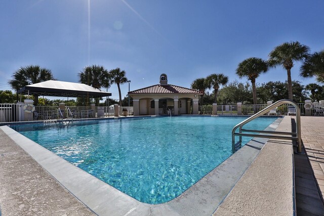 pool featuring a gazebo and fence