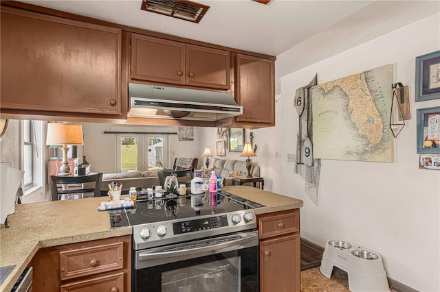 109 Shangri La Cir, Edgewater, FL 32132 - kitchen featuring light countertops, stainless steel range with electric cooktop, brown cabinets, and under cabinet range hood
