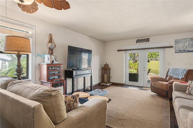 109 Shangri La Cir, Edgewater, FL 32132 - living room with a ceiling fan, wood finished floors, a textured ceiling, french doors, and baseboards