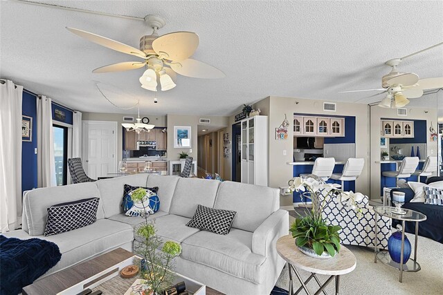 5207 S Atlantic Ave Unit 626, New Smyrna Beach, FL 32169 - living room with a textured ceiling, visible vents, and a ceiling fan