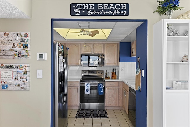 5207 S Atlantic Ave Unit 626, New Smyrna Beach, FL 32169 - kitchen featuring light brown cabinets, light tile patterned floors, backsplash, and appliances with stainless steel finishes
