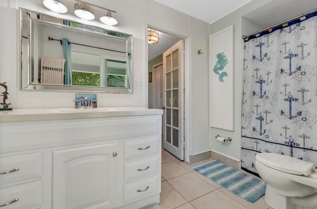 full bath featuring vanity, tile patterned flooring, and toilet