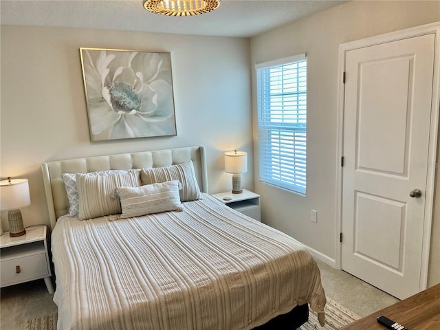 bedroom with baseboards and carpet