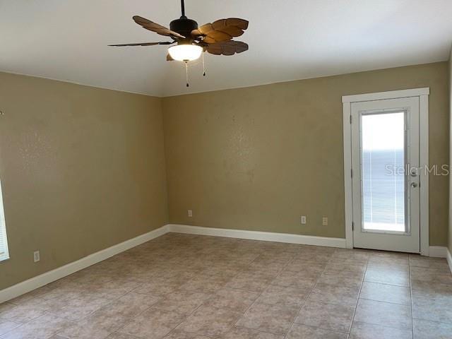 2091 Maltese Ln, New Smyrna Beach, FL 32168 - empty room featuring ceiling fan, baseboards, and light tile patterned flooring
